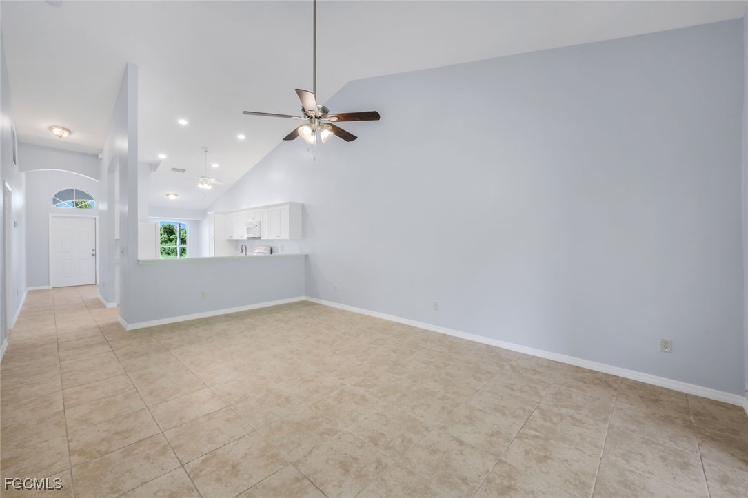 5781-5783 Marina Road Bokeelia, FL 33922 - Photo 34 of 48 a view of a big room with a ceiling fan and a chandelier fan