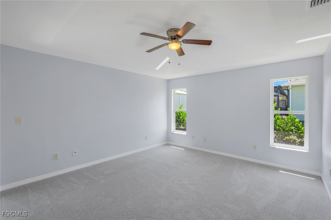 5781-5783 Marina Road Bokeelia, FL 33922 - Photo 38 of 48 an empty room with windows and fan
