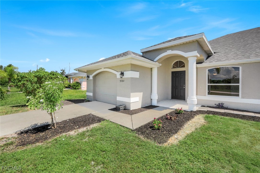 5781-5783 Marina Road Bokeelia, FL 33922 - Photo 4 of 48 a front view of a house with a yard