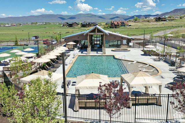 883 Wasatch View Drive, Unit 11 Kamas, UT 84036 - Photo 7 of 14 Community pool with a mountain view, a hot tub, and a patio area