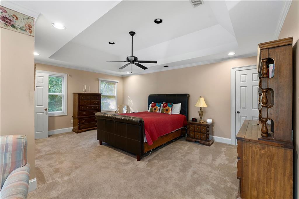 24 Commerce Row Northeast Cartersville, GA 30121 - Photo 17 of 37 a spacious bedroom with a bed and a chandelier