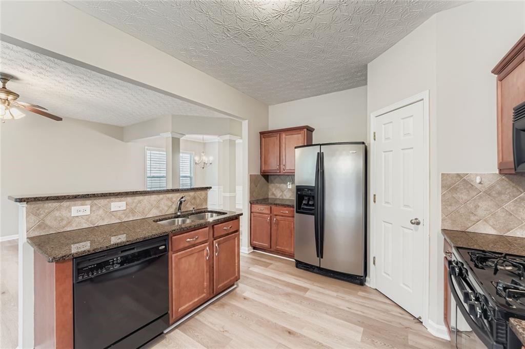 104 Oleander Way Canton, GA 30114 - Photo 12 of 28 a kitchen with stainless steel appliances granite countertop a stove a refrigerator and a refrigerator