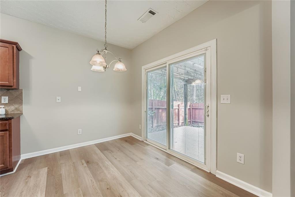104 Oleander Way Canton, GA 30114 - Photo 14 of 28 a view of a room with wooden floor and windows