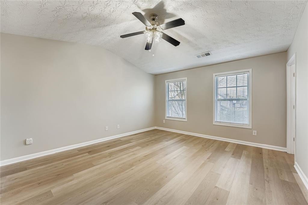 104 Oleander Way Canton, GA 30114 - Photo 16 of 28 wooden floor in an empty room with a window