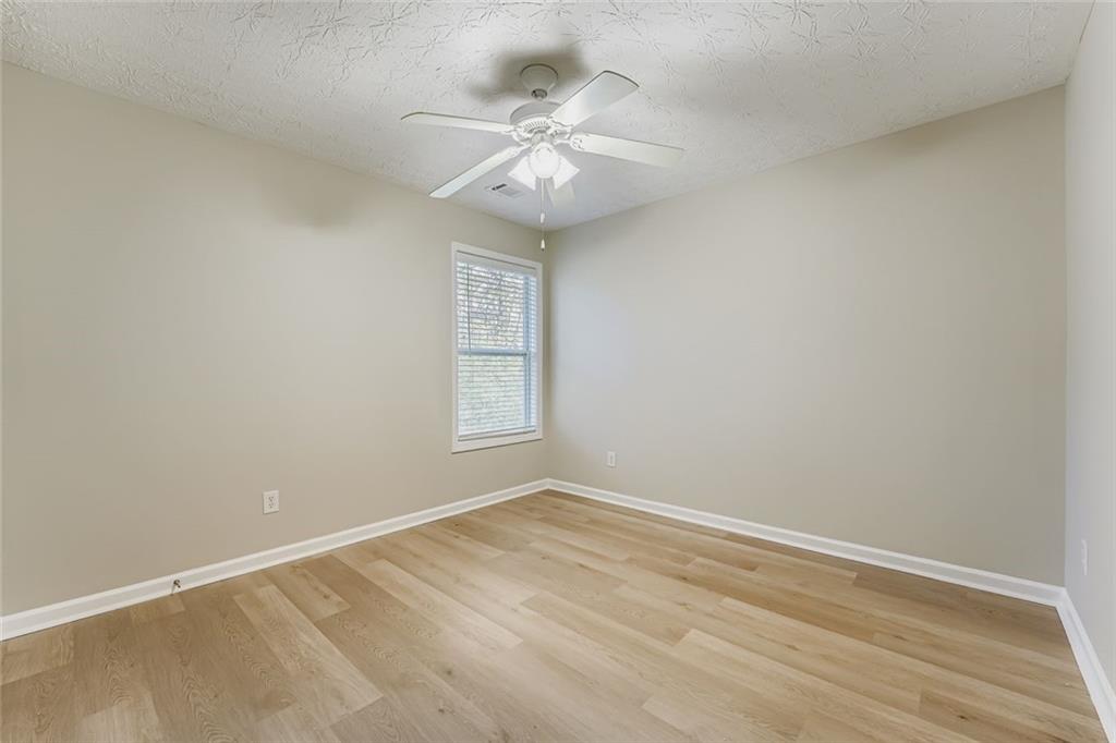 104 Oleander Way Canton, GA 30114 - Photo 21 of 28 an empty room with a window and a fan