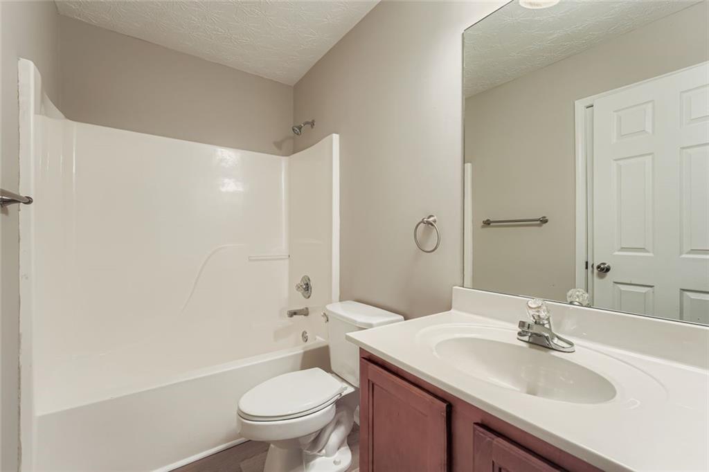 104 Oleander Way Canton, GA 30114 - Photo 23 of 28 a bathroom with a sink a toilet and shower