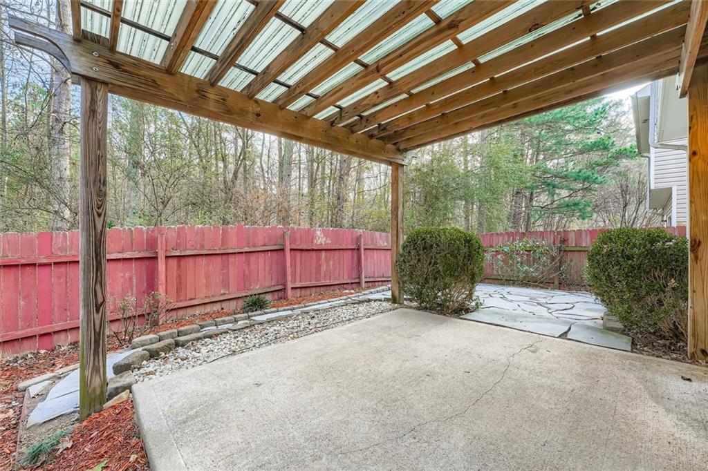 104 Oleander Way Canton, GA 30114 - Photo 26 of 28 a view of backyard with plants and wooden fence