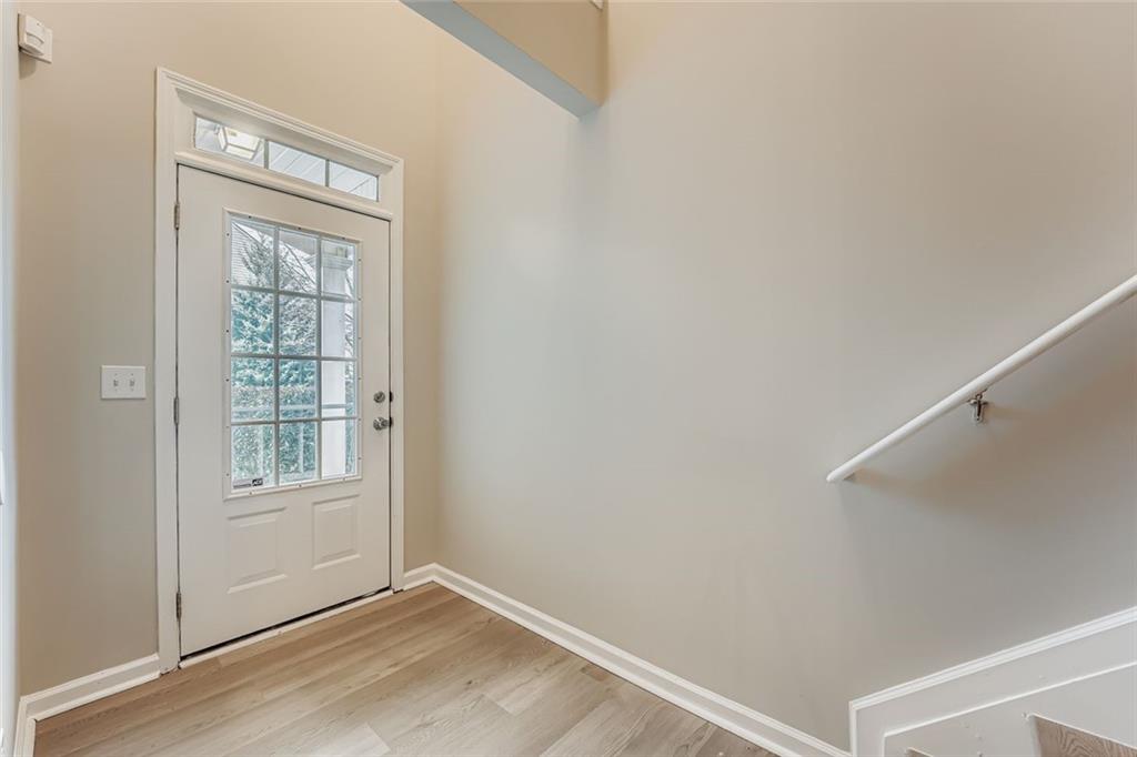 104 Oleander Way Canton, GA 30114 - Photo 4 of 28 a view of an empty room with wooden floor and a window