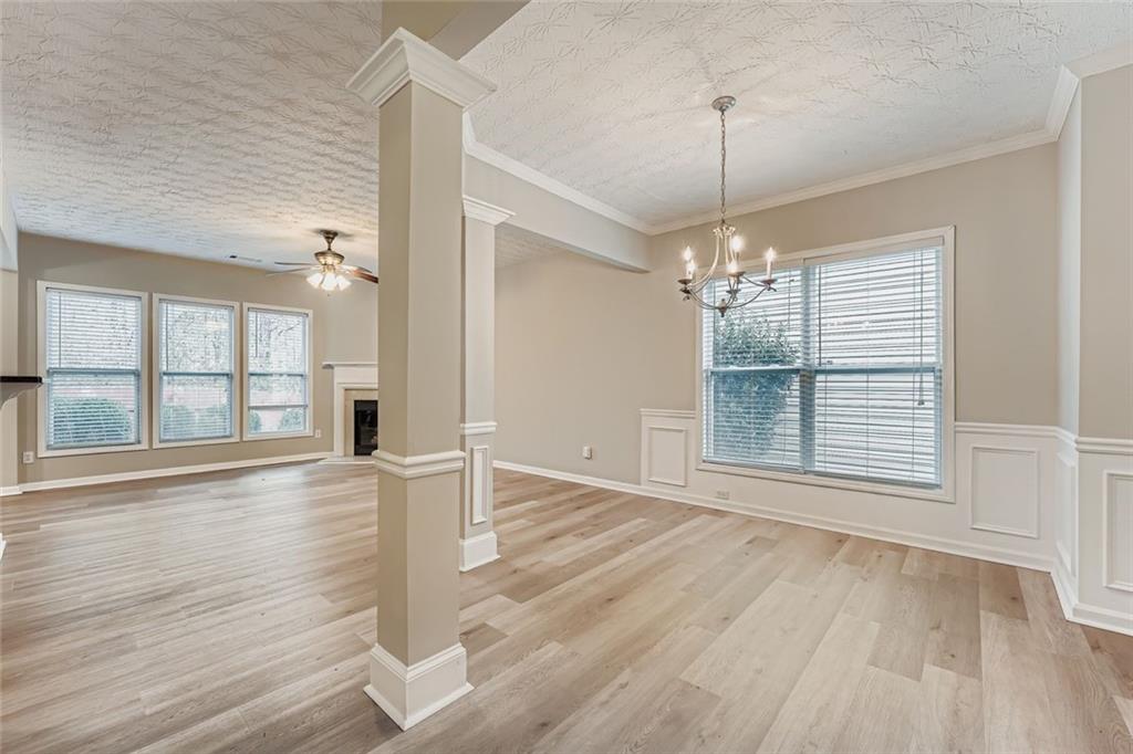 104 Oleander Way Canton, GA 30114 - Photo 8 of 28 an empty room with wooden floor and windows
