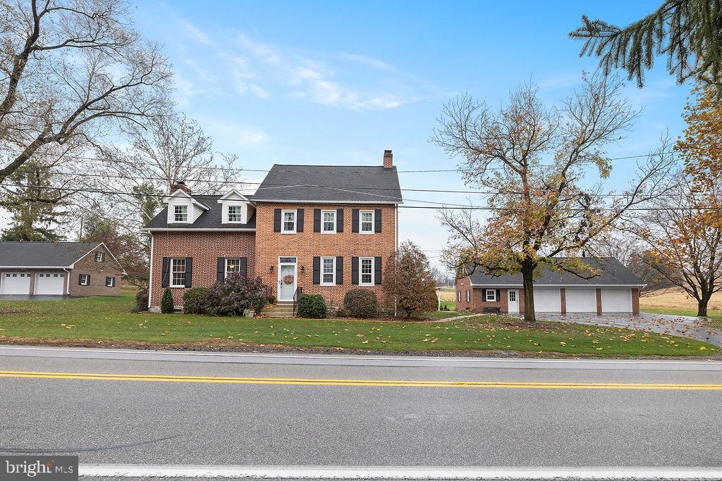 503 Main Street York Springs, PA 17372 - Photo 13 of 62 front view of a brick house next to a yard
