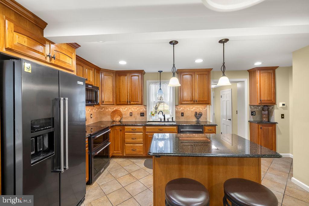 503 Main Street York Springs, PA 17372 - Photo 28 of 62 a kitchen with stainless steel appliances granite countertop a sink a refrigerator and a stove