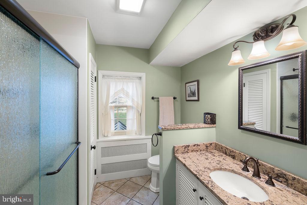 503 Main Street York Springs, PA 17372 - Photo 48 of 62 a bathroom with a granite countertop sink toilet and shower