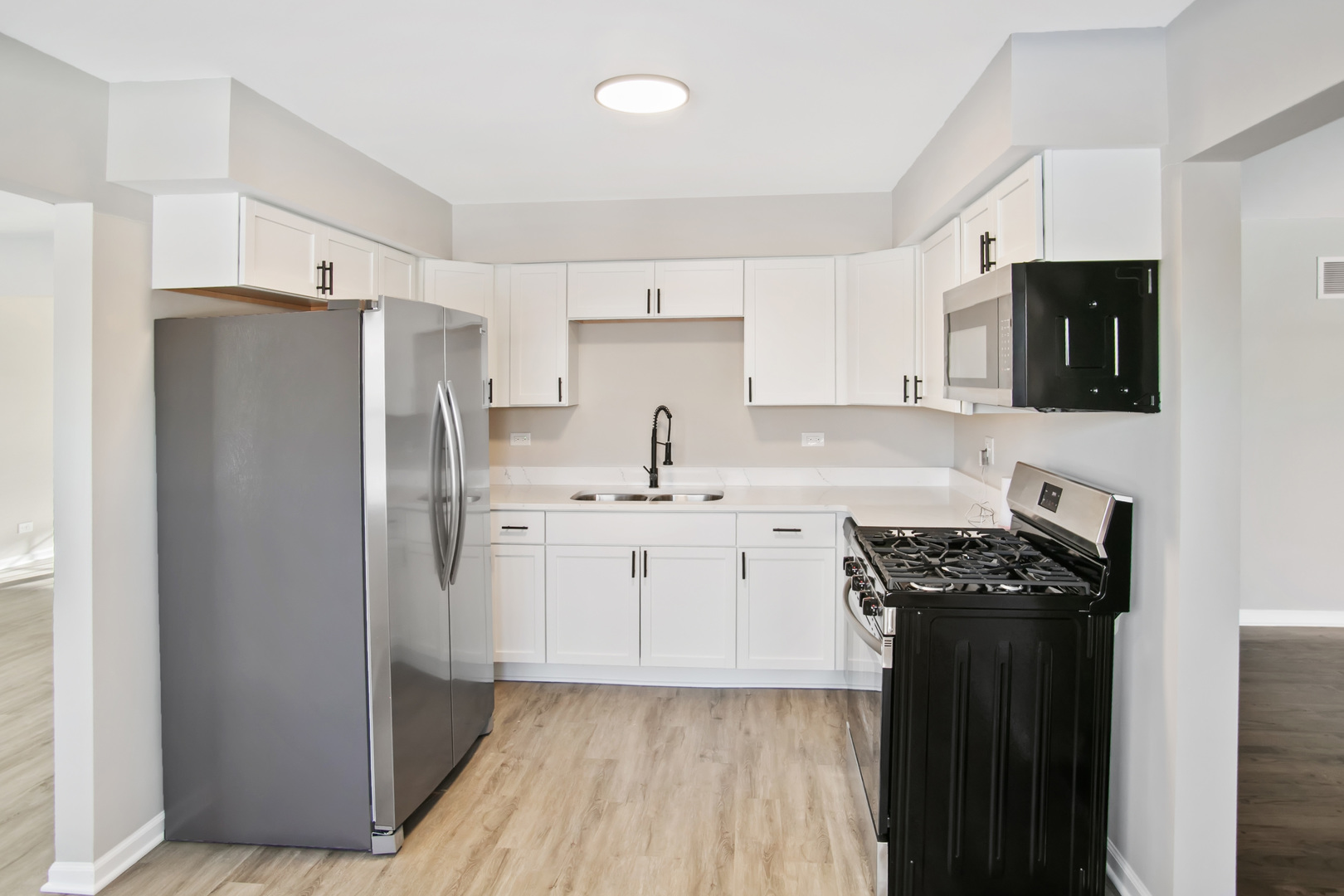 3451 Ithaca Road Olympia Fields, IL 60461 - Photo 6 of 29 a kitchen with stainless steel appliances a refrigerator stove and sink
