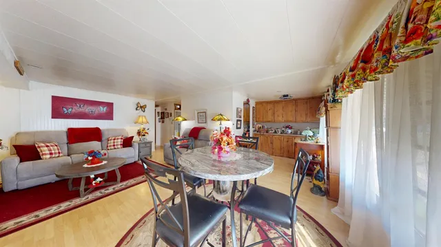 a dining room with furniture and a rug