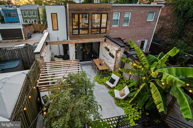 a view of a patio with table and chairs potted plants