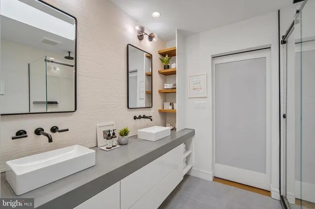 a bathroom with a double vanity sink mirror and