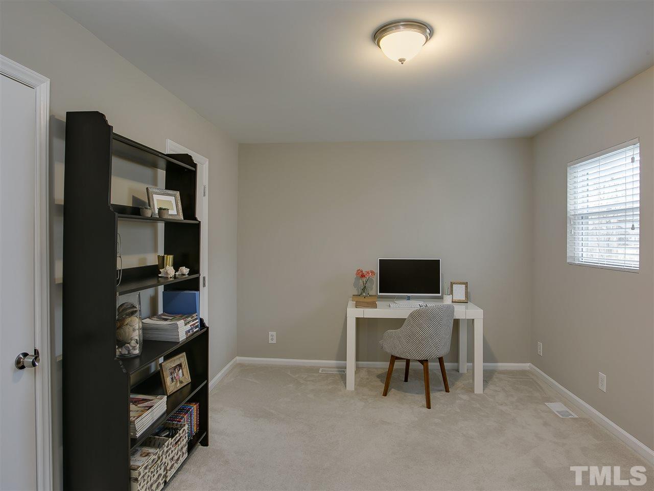 5114 Raintree Road Durham, NC 27712 - Photo 22 of 30 a workspace with furniture and white cabinet