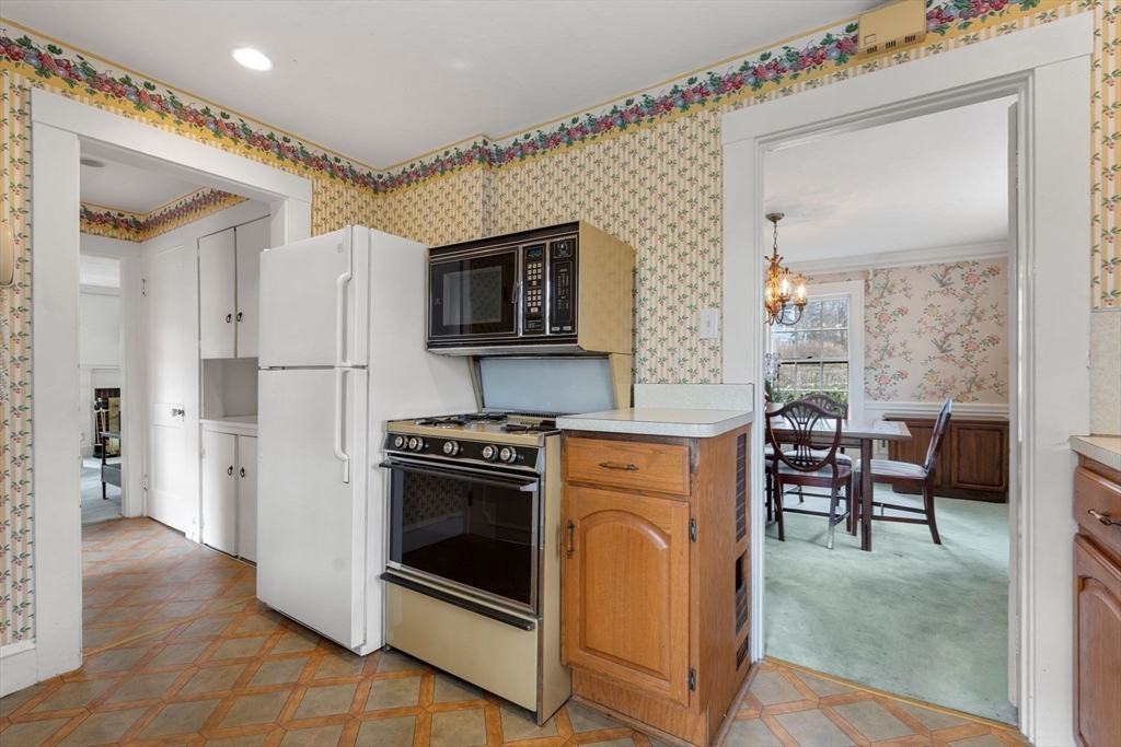 22 Arden Road Newton, MA 02460 - Photo 13 of 28 a kitchen with stainless steel appliances granite countertop a stove a sink and a refrigerator