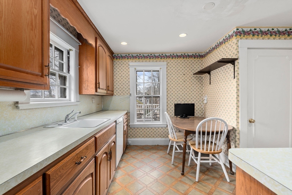 22 Arden Road Newton, MA 02460 - Photo 15 of 28 a kitchen that has a sink and chairs in it