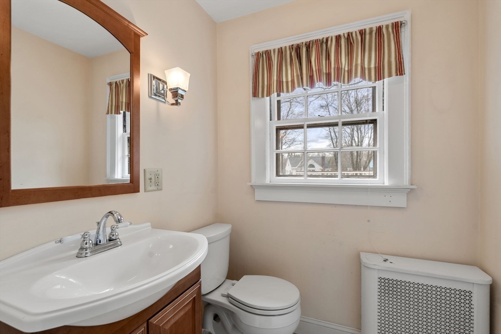 22 Arden Road Newton, MA 02460 - Photo 18 of 28 a bathroom with a sink a toilet and a mirror