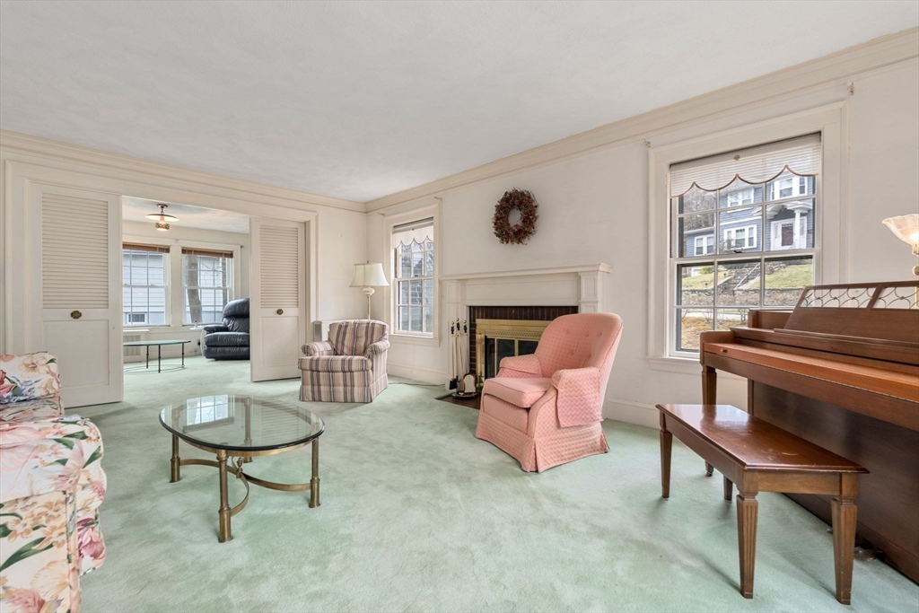 22 Arden Road Newton, MA 02460 - Photo 5 of 28 a living room with furniture and a fireplace