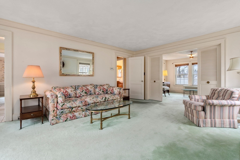 22 Arden Road Newton, MA 02460 - Photo 7 of 28 a living room with furniture and a table