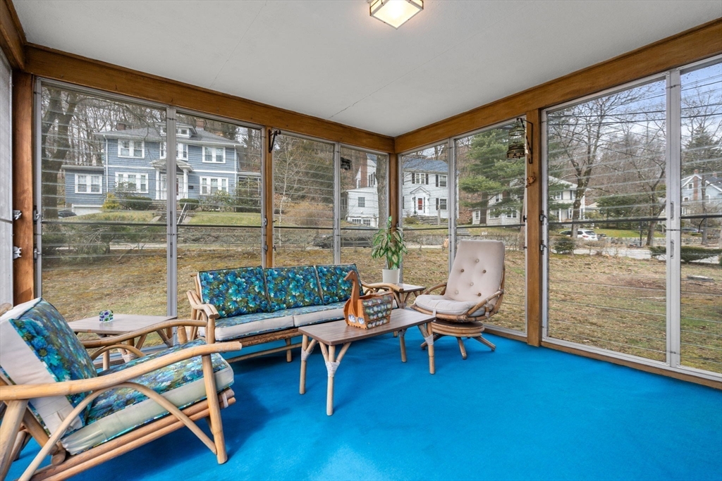 22 Arden Road Newton, MA 02460 - Photo 10 of 28 a living room with furniture and a floor to ceiling window