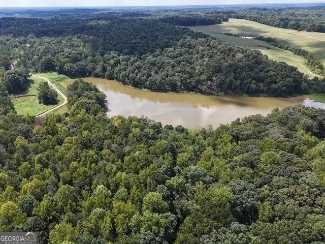 an aerial view of a houses with outdoor space and lake view