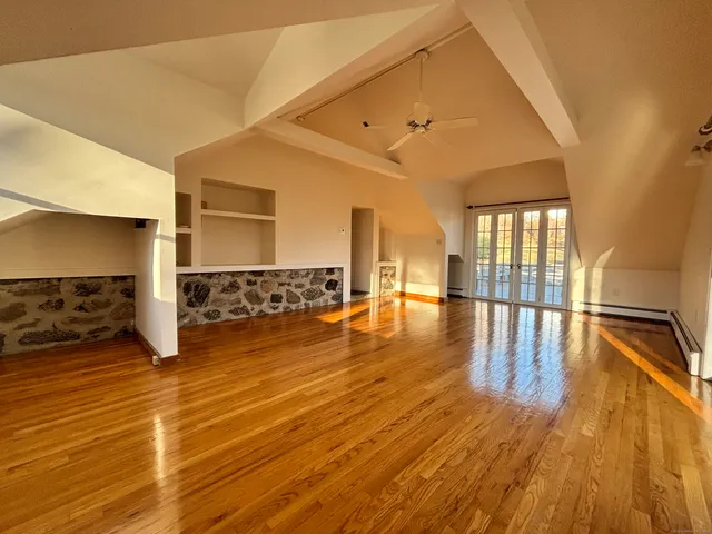 a view of a room with wooden floor
