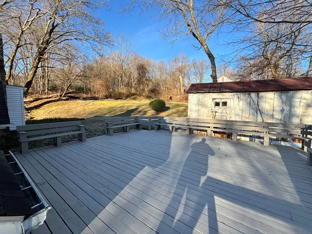 a view of a livingroom with wooden floor and a fireplace