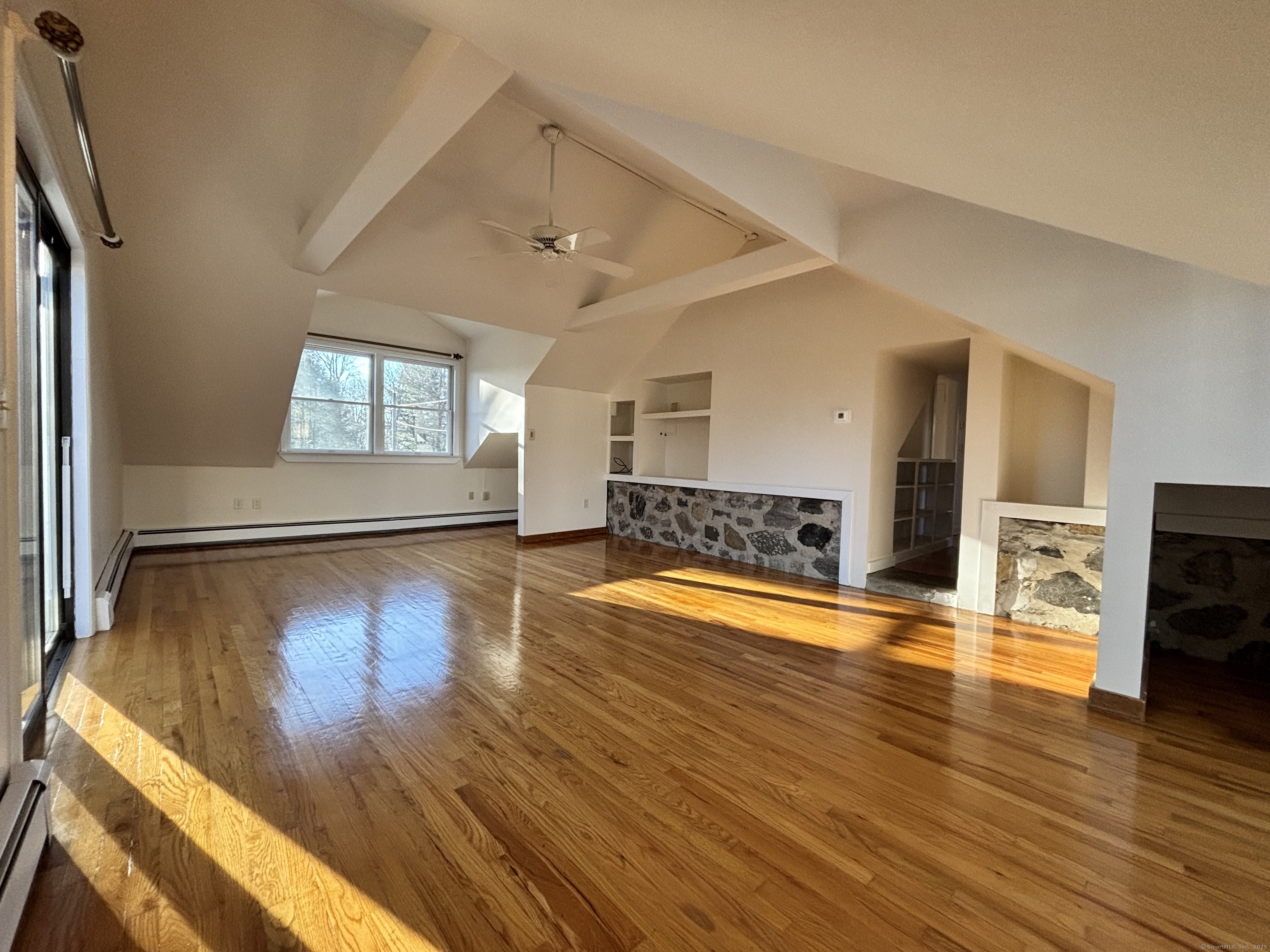 65 B Cross Highway Redding, CT 06896 - Photo 21 of 25 a view of a livingroom with wooden floor and a fireplace