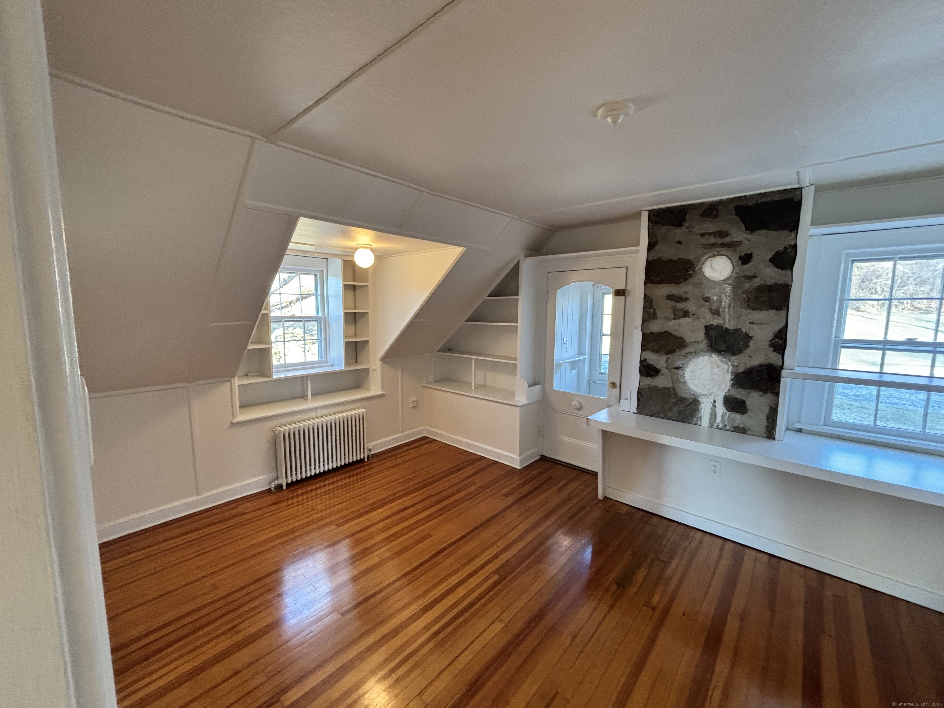 65 B Cross Highway Redding, CT 06896 - Photo 3 of 25 an empty room with wooden floor and windows