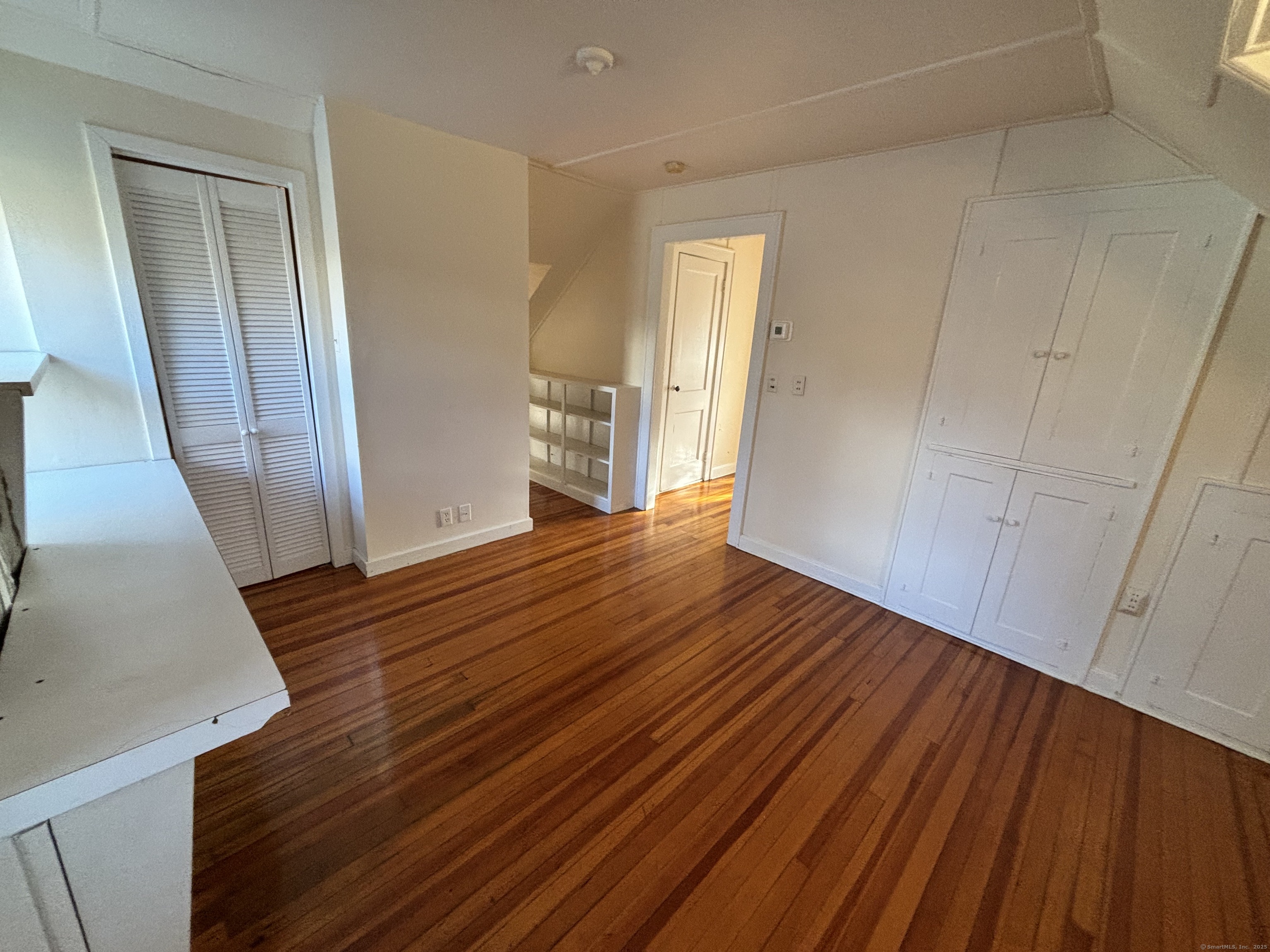 65 B Cross Highway Redding, CT 06896 - Photo 4 of 25 a view of a room with wooden floor and staircase