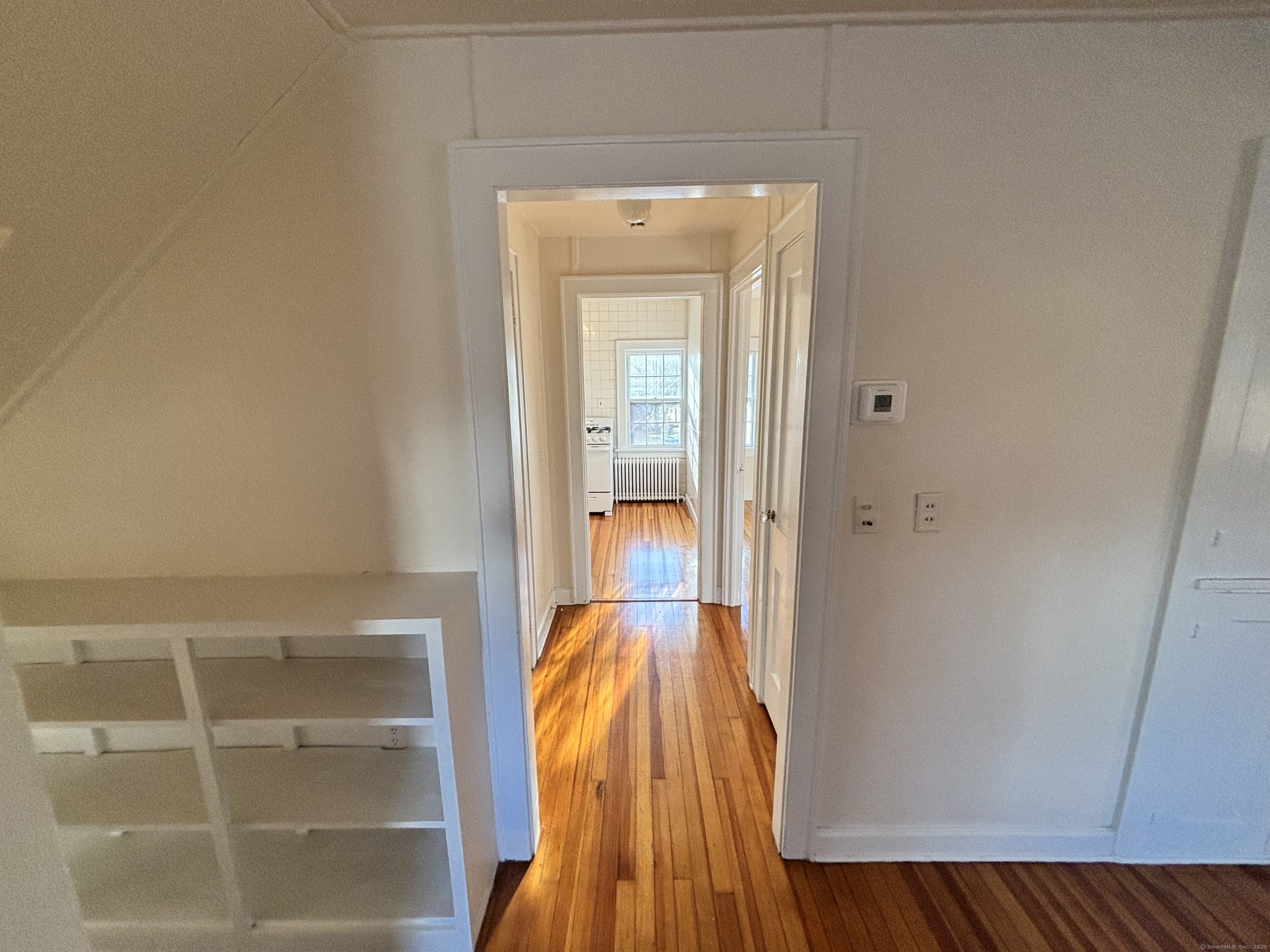 65 B Cross Highway Redding, CT 06896 - Photo 5 of 25 a view of a hallway with wooden floor and a bathroom