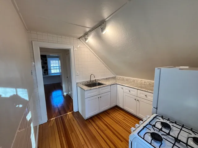 a kitchen with sink cabinets and stove top oven