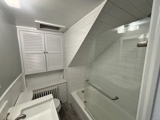 a bathroom with a bathtub and a shower