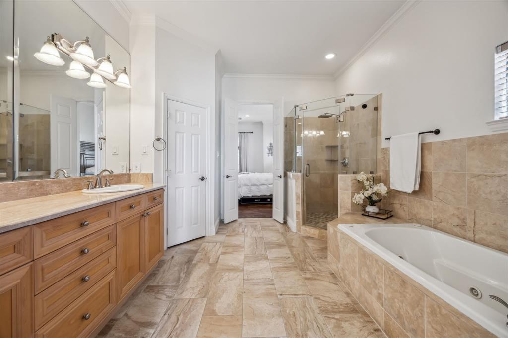 1012 Pavillion Street Dallas, TX 75204 - Photo 16 of 30 Spa-like bath featuring dual sinks, separate shower, soaking tub, and large walk-in closet.