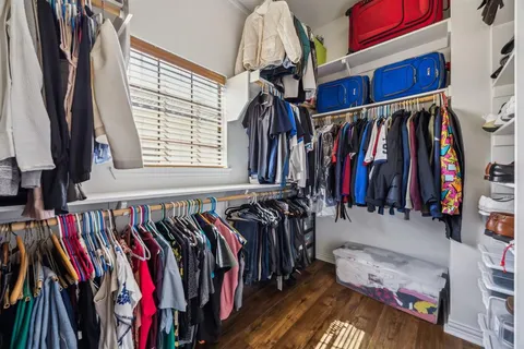 a view of walk in closet with clothes and shoes