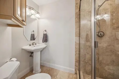 a bathroom with a sink toilet and shower