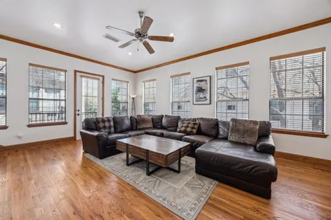 a living room with furniture and wooden floor