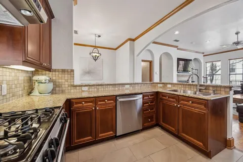 a kitchen with stainless steel appliances granite countertop a sink and cabinets