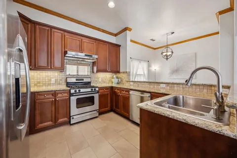 a kitchen with a sink stove and refrigerator