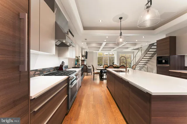 a large kitchen with stainless steel appliances kitchen island a large counter space a sink and cabinets
