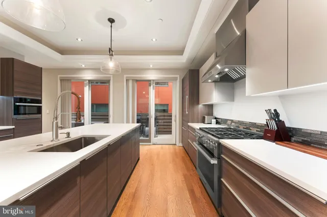 a kitchen with granite countertop a sink stove and cabinets
