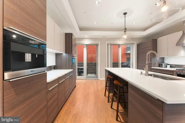 a large kitchen with stainless steel appliances a lot of counter space and a large window