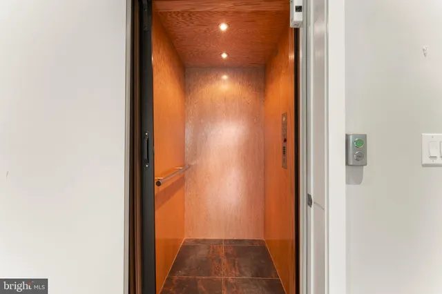 a bedroom with furniture and a large window