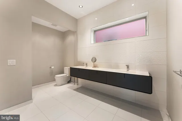 a en suite bathroom with a sink a mirror and a shower