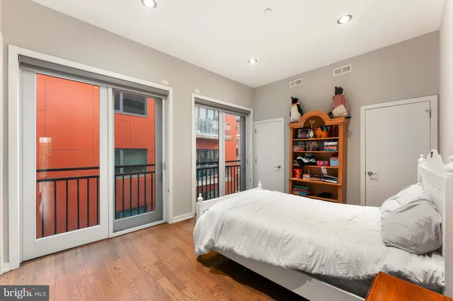 a bedroom with a bed and a view of kitchen
