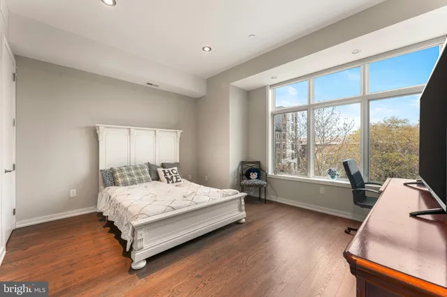 a bedroom with a bed and a television in it