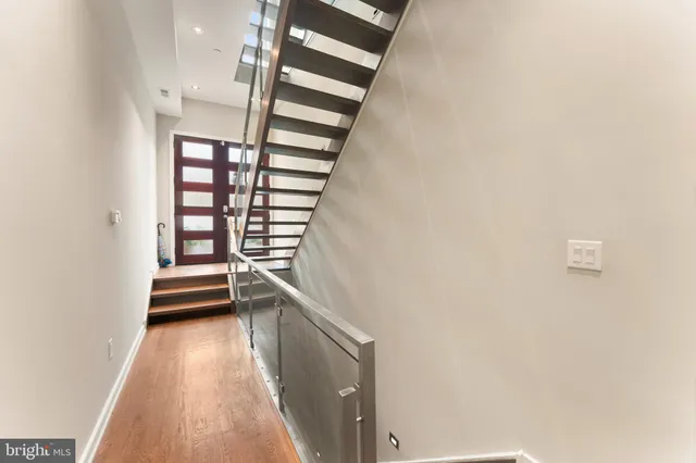 a view of entryway with stairs and wooden floor